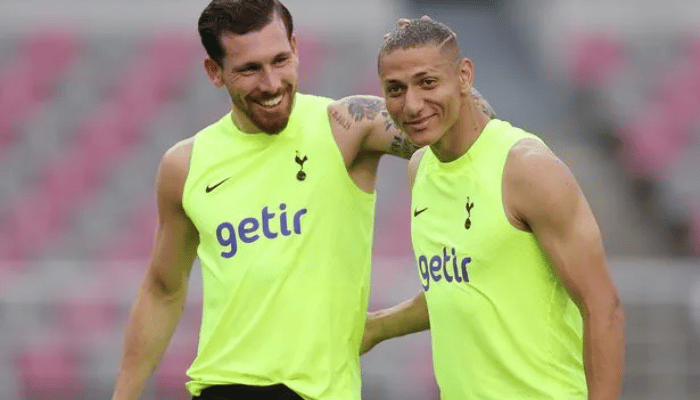 Camisa de Treino Nike Tottenham 2022 em Volt e Preto, destacando o Swoosh e escudo do clube em detalhes pretos. Logotipo do patrocinador em roxo para um toque de elegância.